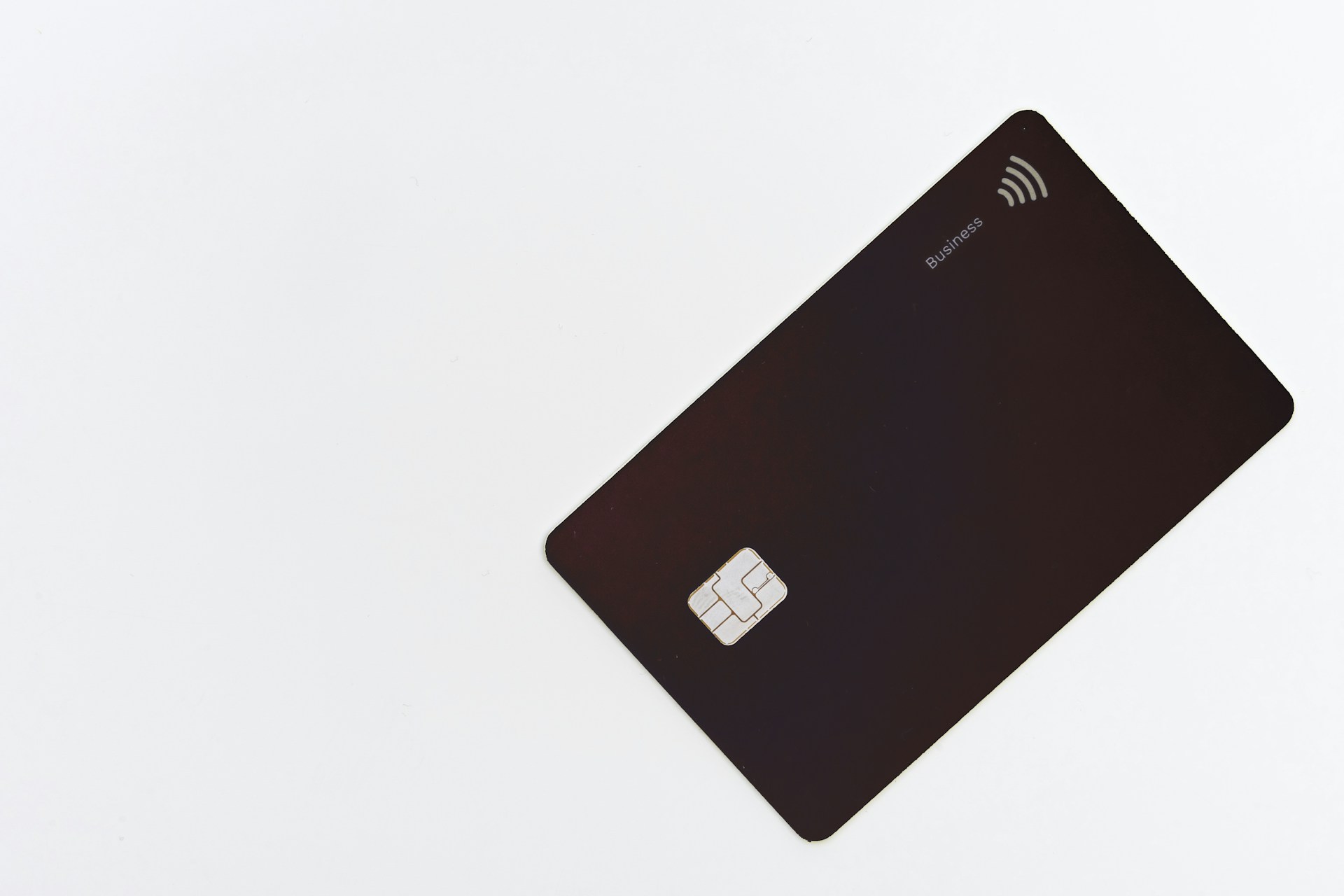 Black credit card placed on a white surface