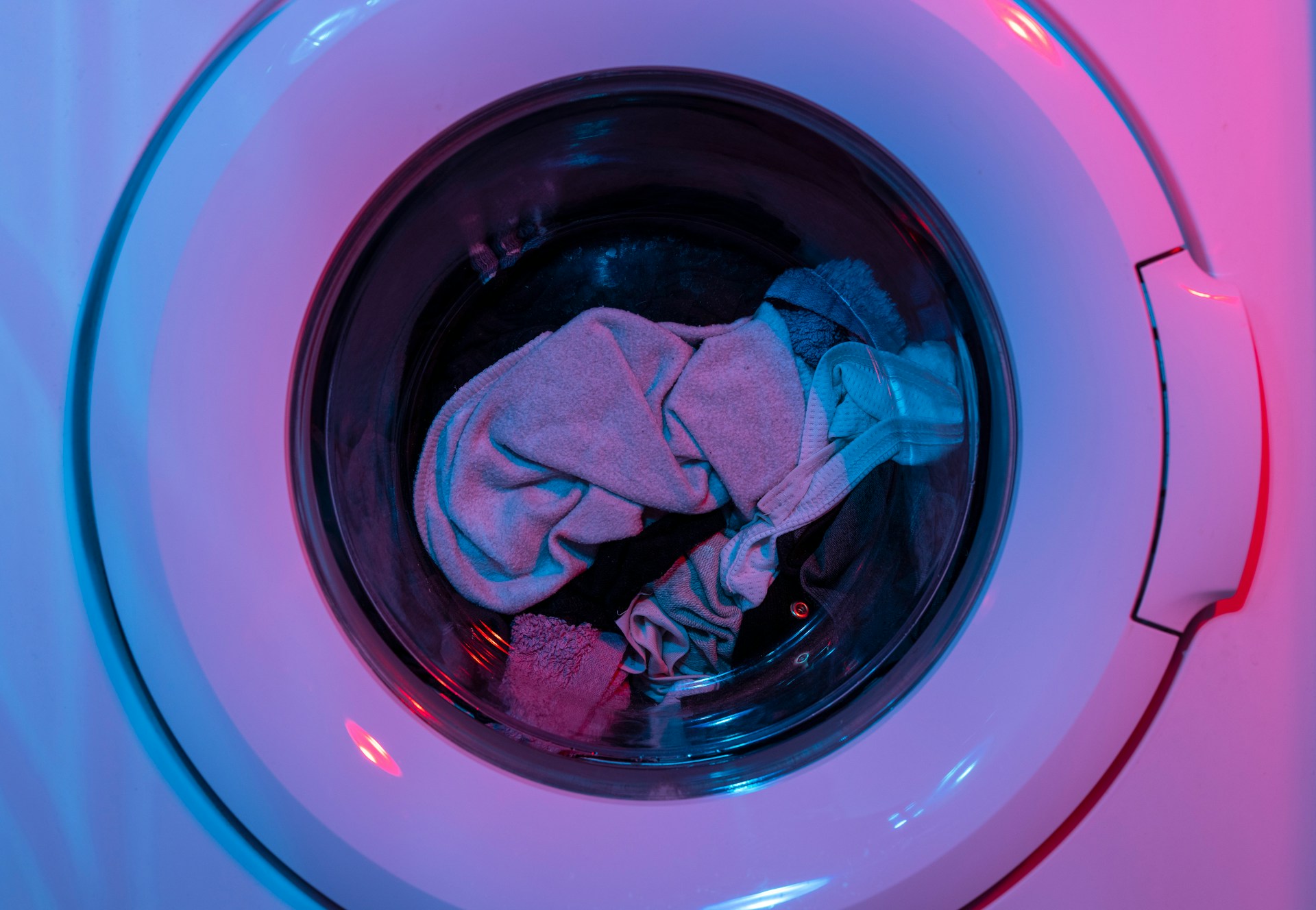 Clothes inside a washing machine drum during a wash cycle