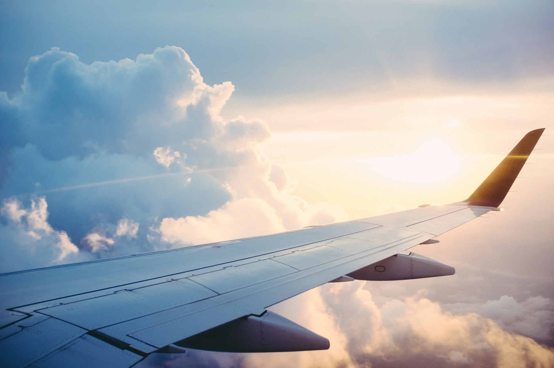 Aerial view of a commercial airplane flying above the clouds