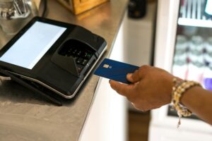Close-up of a hand holding a credit card during a payment transaction