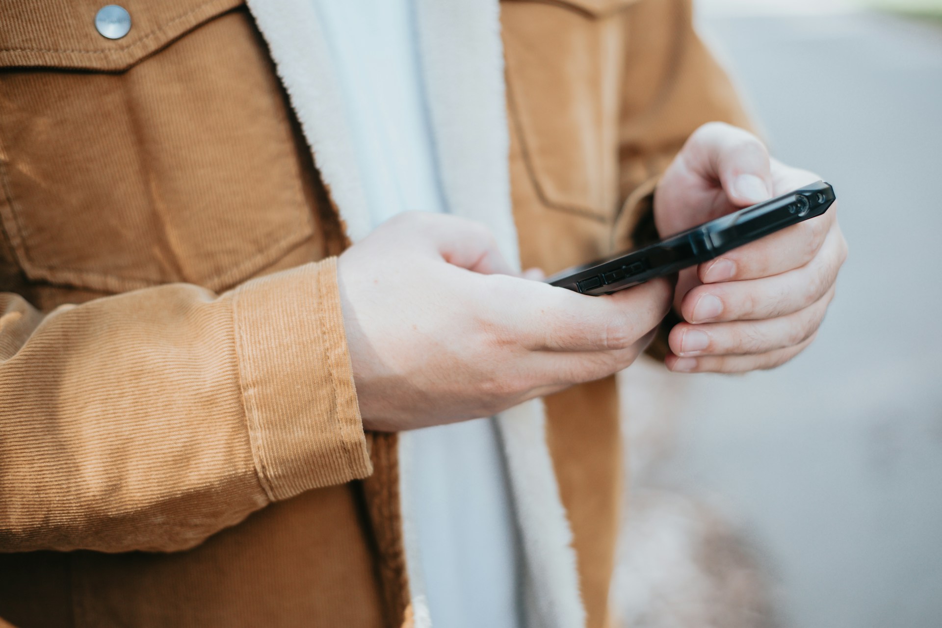 Close-up of a person holding a smartphone in their hand