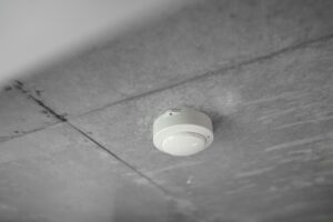 A smoke detector mounted on a ceiling