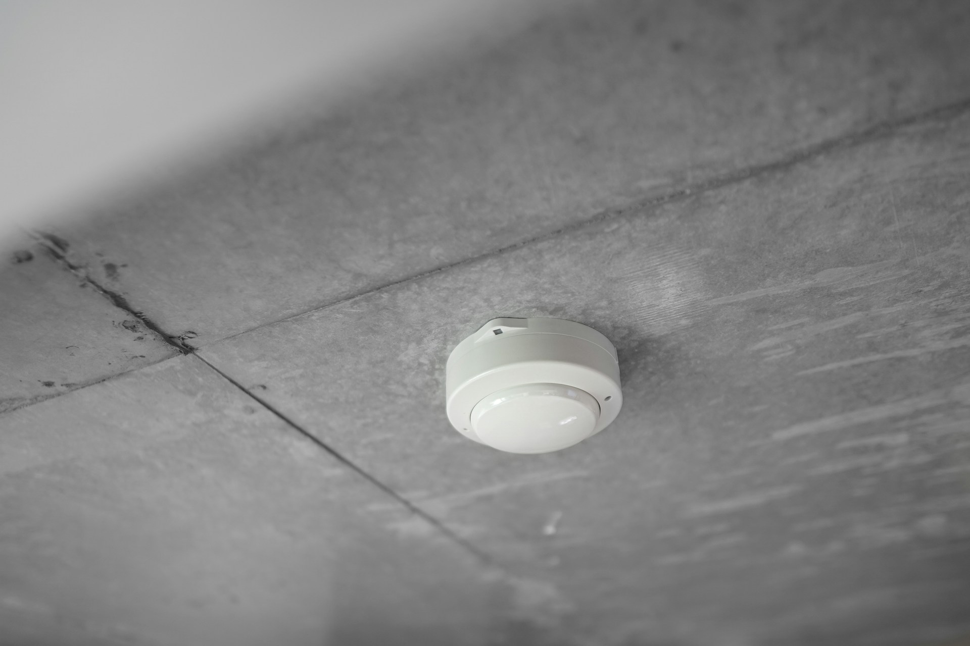 A smoke detector mounted on a ceiling