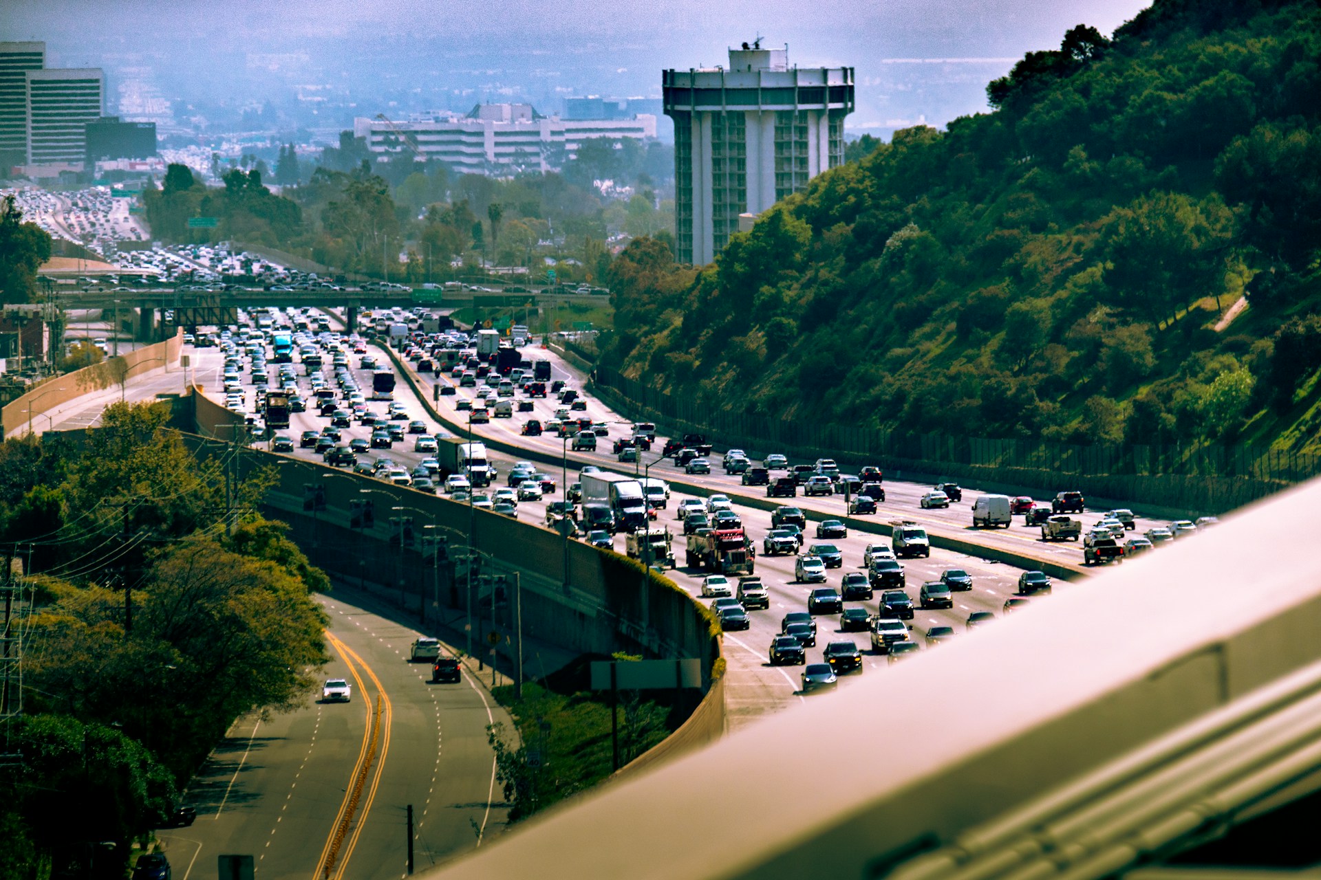Heavy traffic forming near a highway merge with multiple lanes of cars slowing.