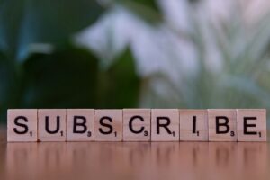 Wooden blocks spelling “subscribe” on a table