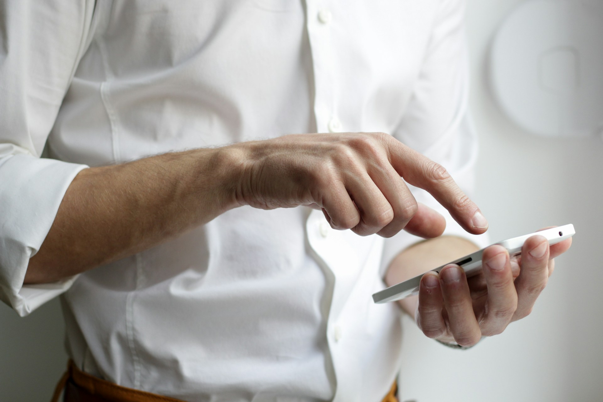 Person holding a smartphone while using the screen