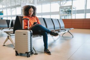 Passenger sitting at an airport gate waiting near a boarding area