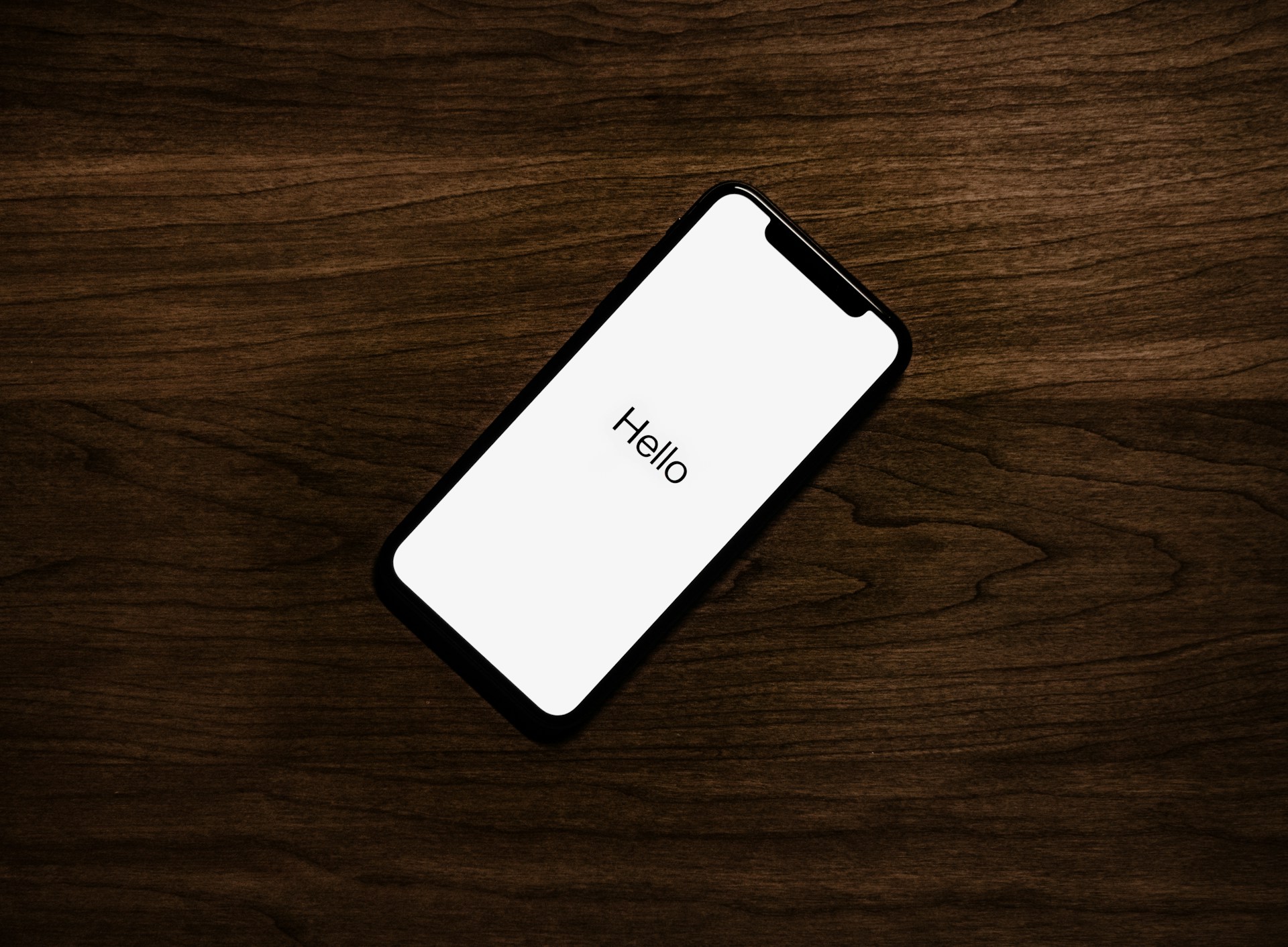Smartphone on a table displaying a setup or welcome screen after reset