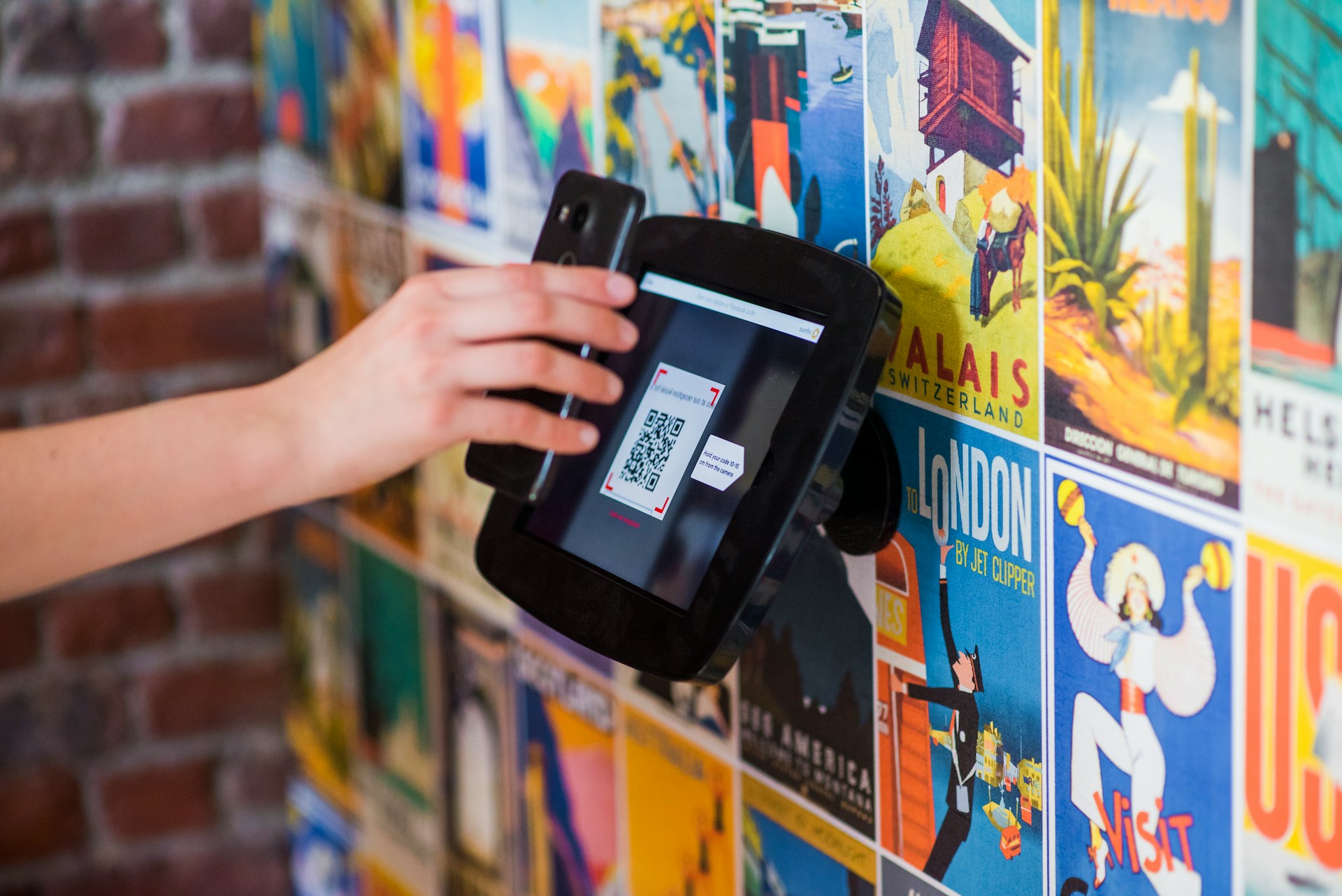 Person scanning a QR code using a payment terminal