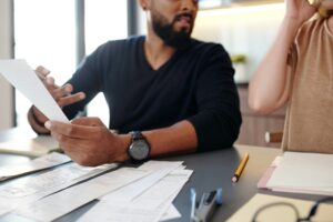Two people looking at a bill together and reviewing the charges