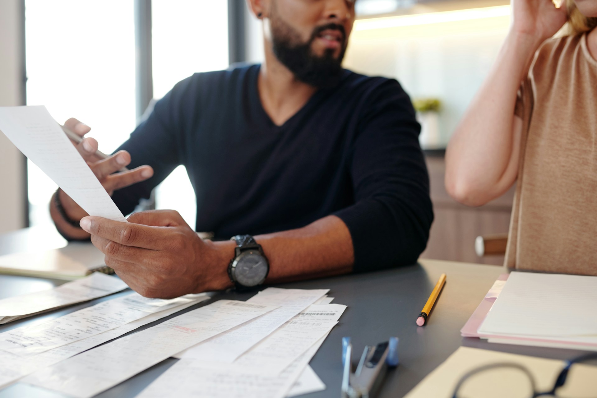 Two people looking at a bill together and reviewing the charges