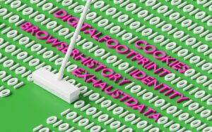 Laptop screen displaying a website cookie consent popup next to a cleaning mop on a green surface