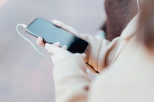 Person holding and looking at a smartphone while using it