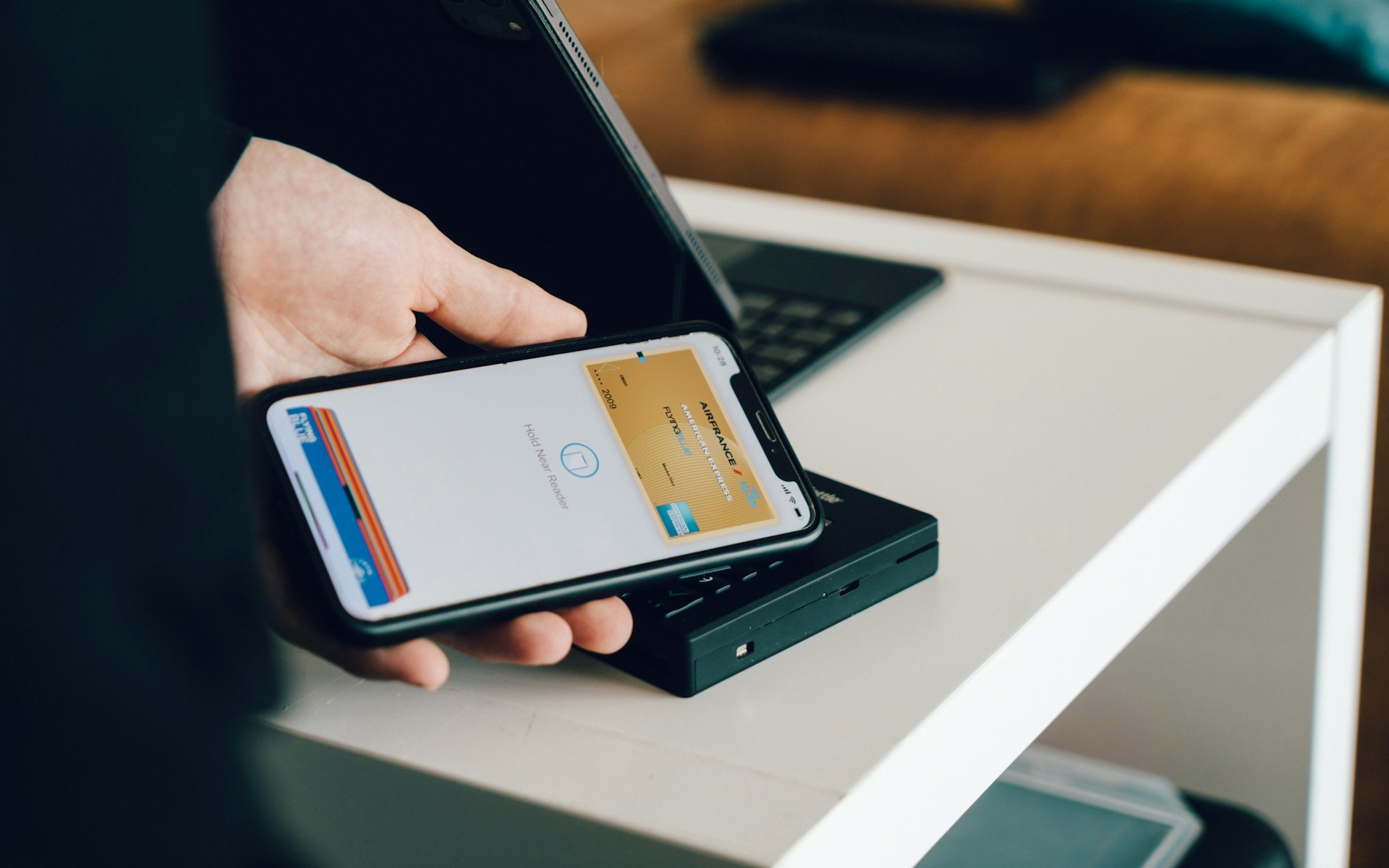 Person holding a smartphone displaying a digital wallet payment app.
