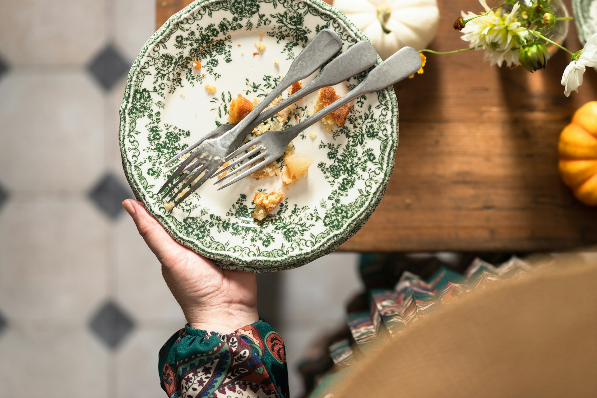 Person holding an empty plate after finishing a meal.