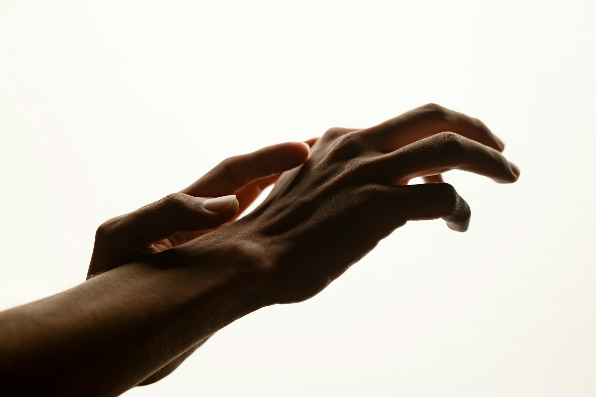 Two hands reaching toward each other with fingers slightly extended, illustrating hand movement and coordination.