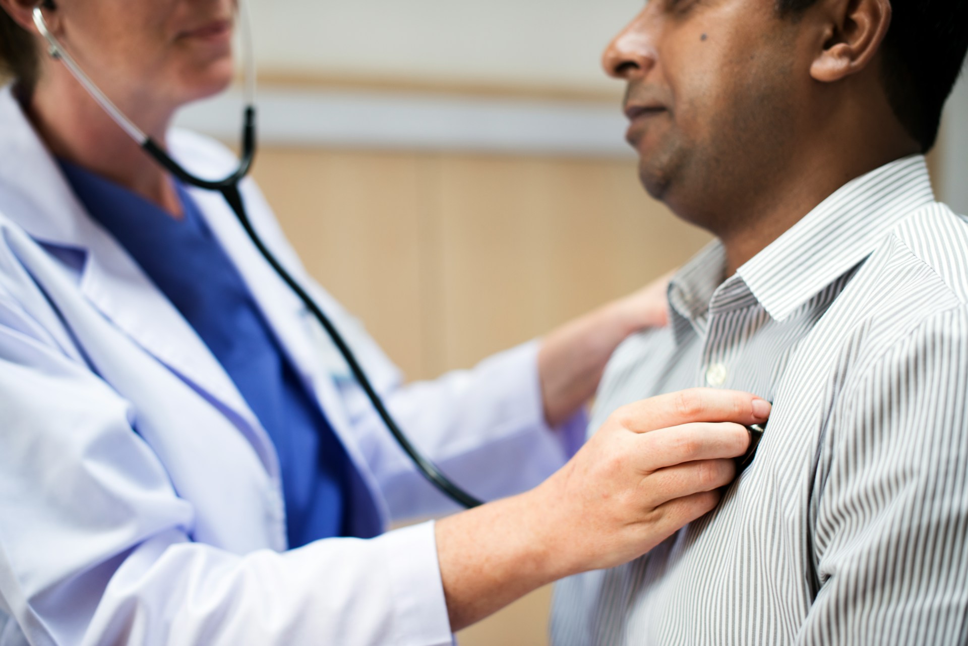 Healthcare professional checking a person's pulse at the wrist.