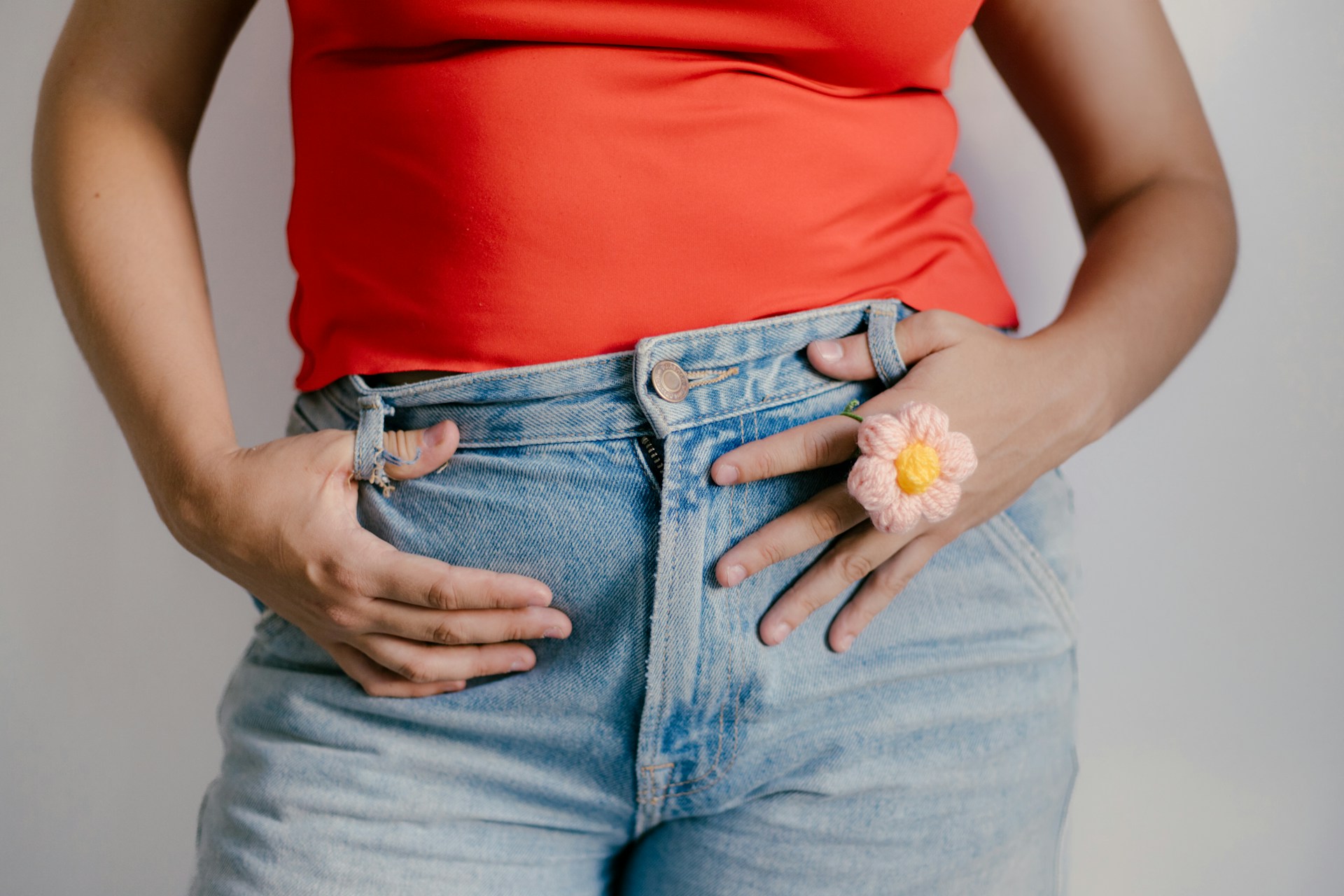 Close-up of hands resting on the abdomen to represent stomach growling and normal digestion.
