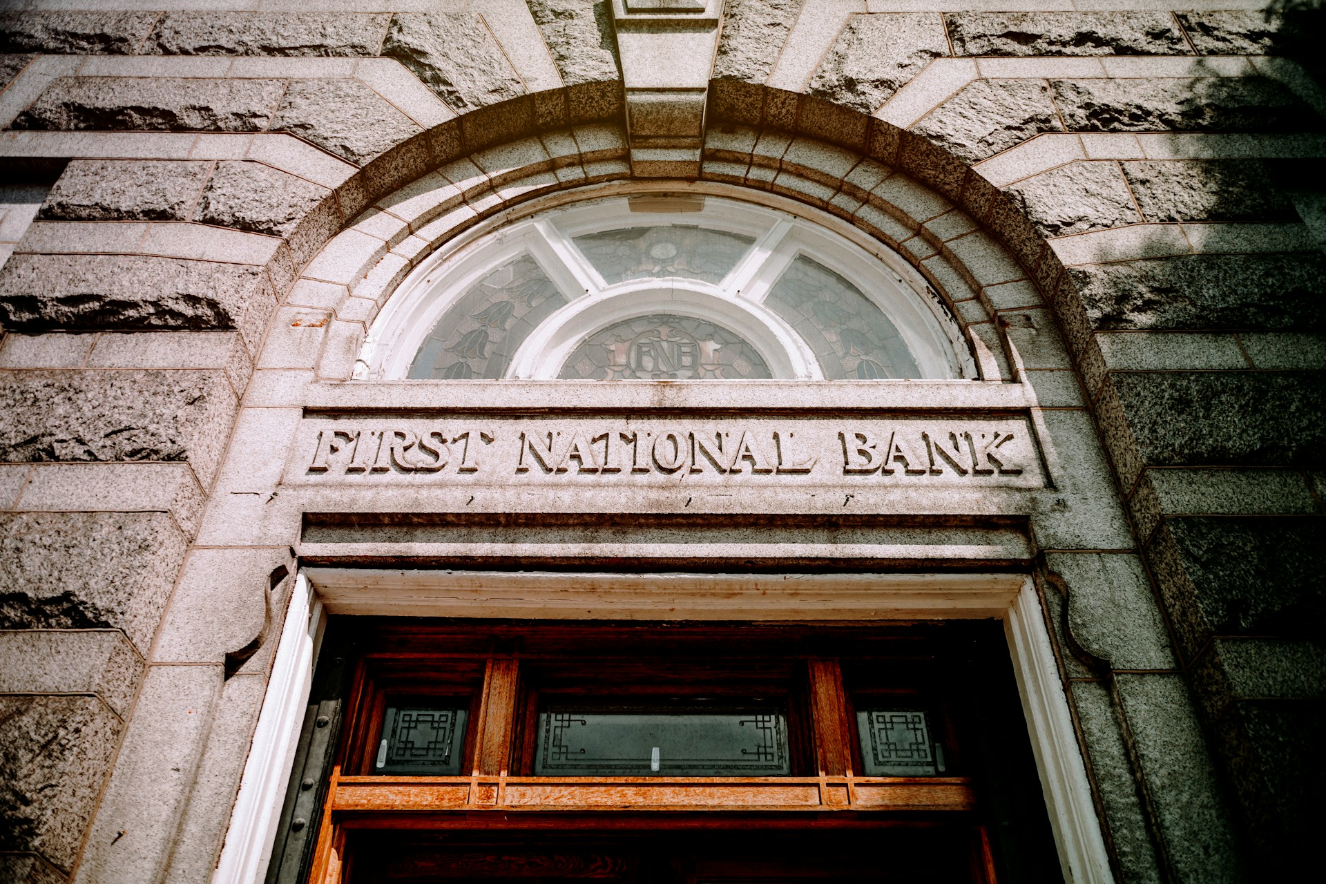 Exterior of a bank building with a traditional stone entrance