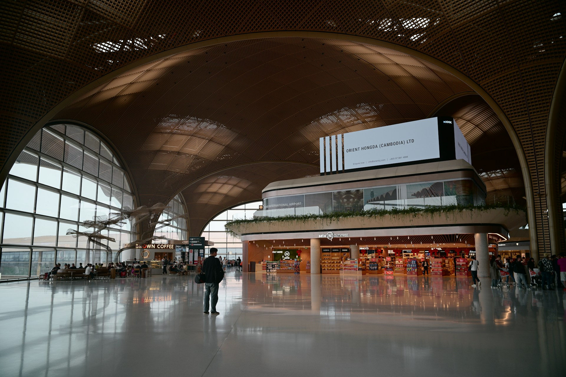 Modern airport terminal with seating and large arched windows