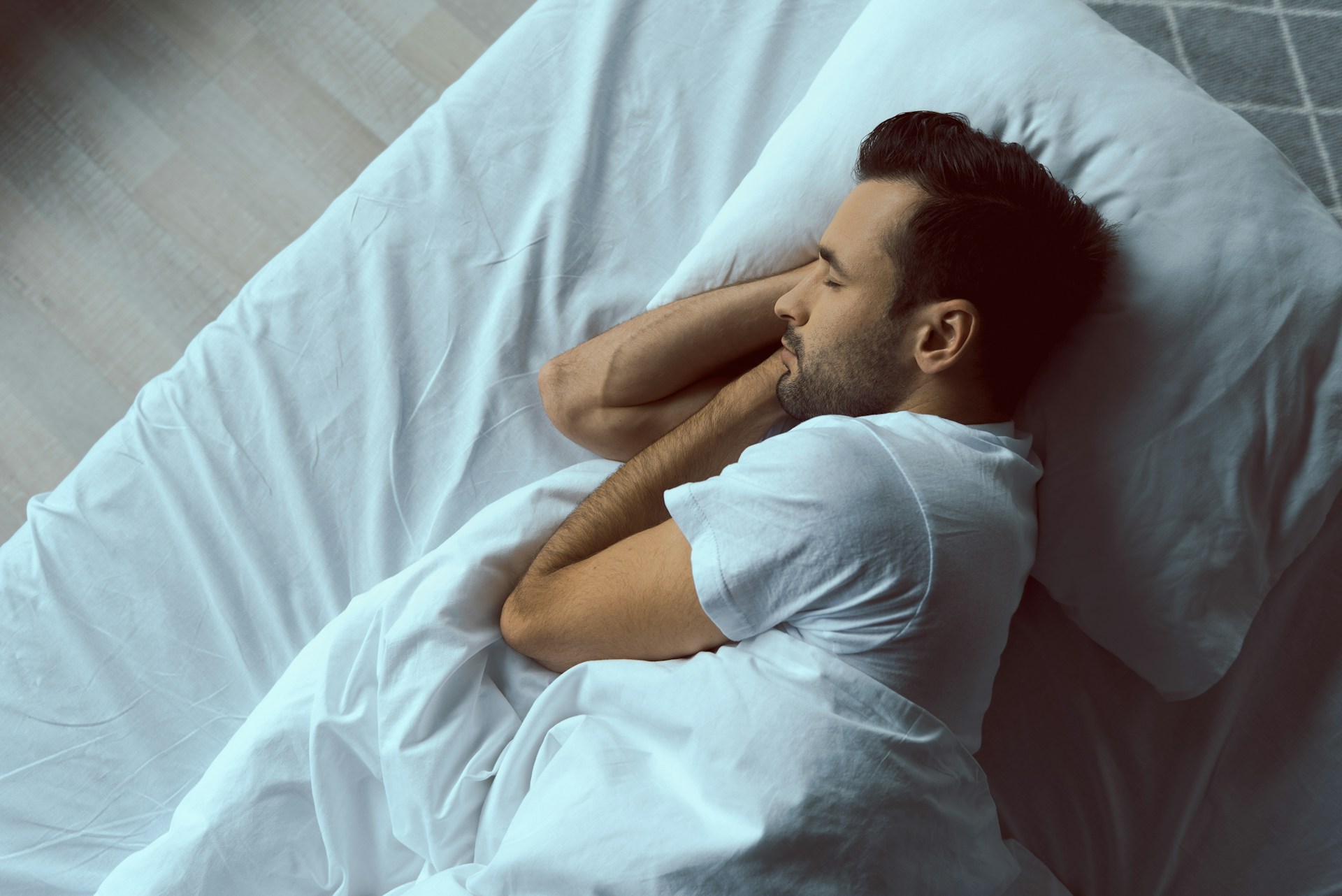 Person sleeping peacefully on a pillow during the night.
