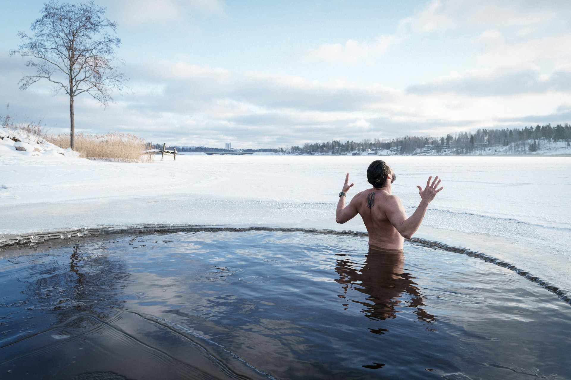 Person standing in cold water with bare skin exposed to low temperatures.